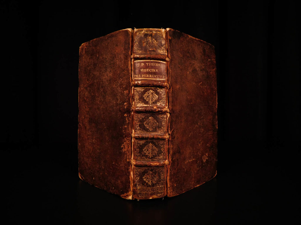 1690 1st ed history of wigs & headwear hats perruques french clergy jean thiers | <em>jean-baptiste thiers was a 17<sup>th</sup>-century french clergyman, who curiously, is best known for a treatise on the history and use of the wig. During his tenure at the diocese of chartres, there was a prohibition established on the ecclesiastical use of wigs. Thiers wrote this work to discuss the evolution of wigs and other headpieces and sought to show why they should be allowed. He covers hair barrettes, square caps, capuchins, chainmail aventails, and other forms of protective and cosmetic headdresses. </em>
