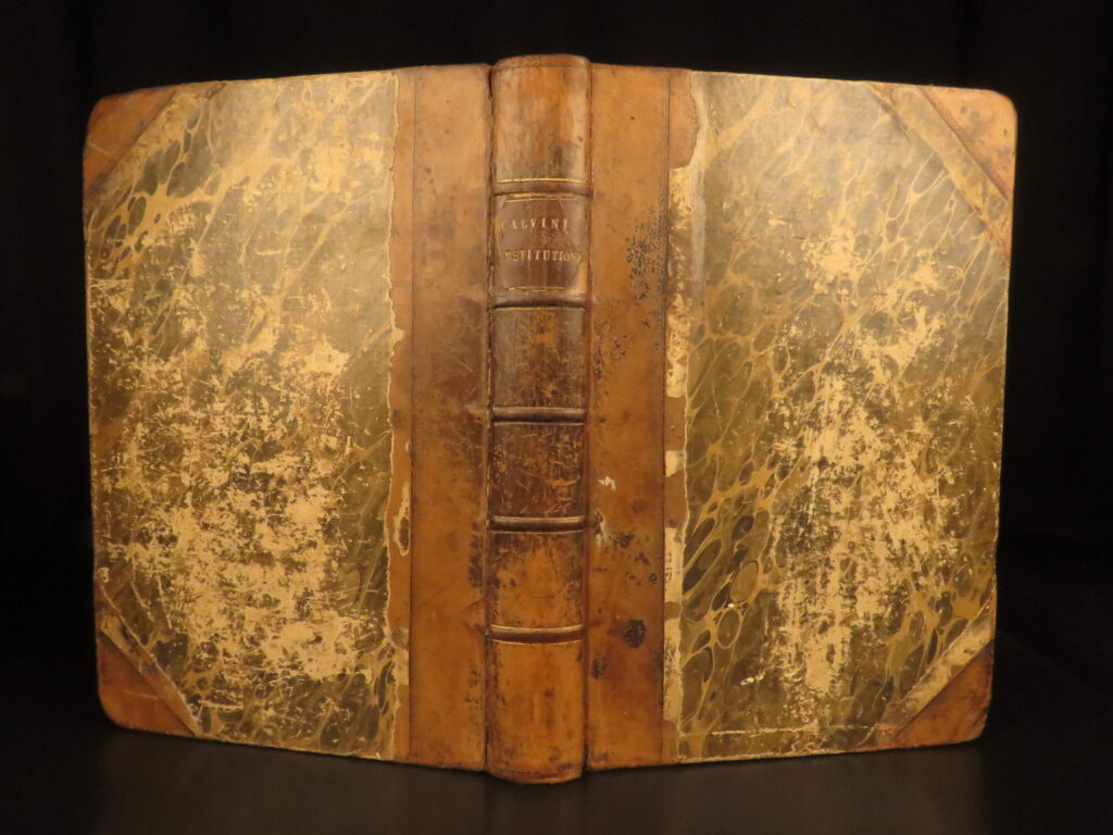 1568 – jean calvin, institutes of christian religion | geneva folio, calvinism | 1568 geneva folio edition of calvin’s latin institutio christianae religionis, bound in leather with marlorat’s indices, printed by franciscus perrinus.